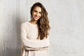 istock Smiling pretty girl in knitted sweater in studio 1169983073