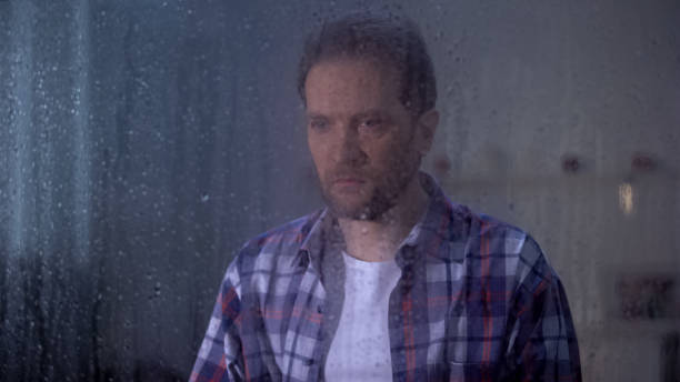 istock Frustrated man suffering depression, awful news, relative death, rainy window 1169983357