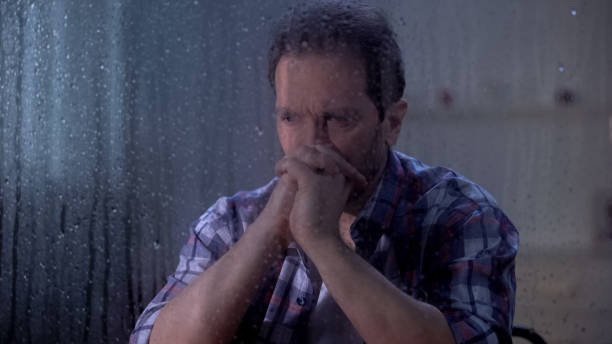 istock Hopeless man thinking about life and health problems on rainy day, depression 1169983394
