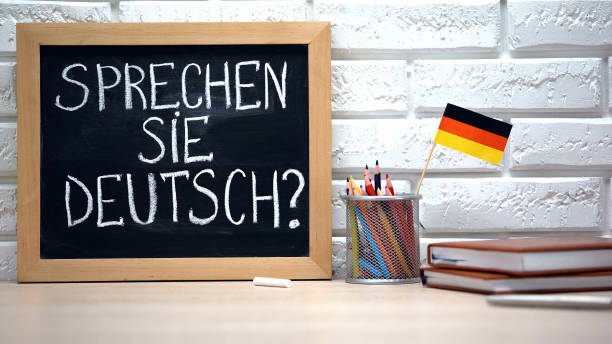 istock Do you speak German written on board, international flag in box, language 1169984584