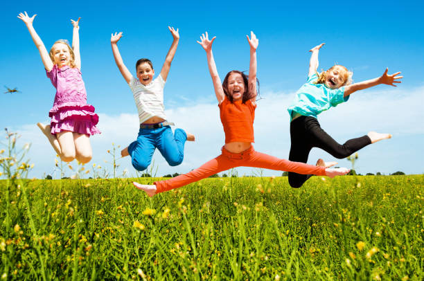 istock Happy active children jumping outdoors 1169985542