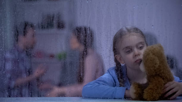 istock Sad girl holding teddy bear, parents conflicting, feeling stressed and insecure 1169986148