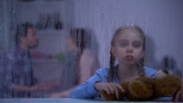 istock Upset girl with teddy bear feeling stressed, parents conflicting, family problem 1169986781