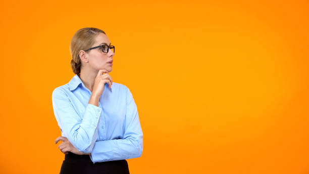 istock Thoughtful business lady making choice on bright background, taking decision 1169986825