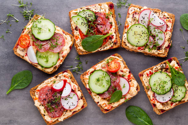 istock Sandwiches with cream cheese, vegetables and salami. 1169986871