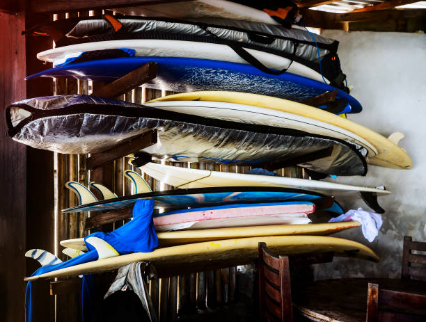 Surfer boards under roof for rental Surfer boards on shelf  lie one under one under the roof for rental hull house stock pictures, royalty-free photos & images