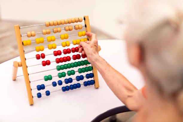 istock Old Woman make exercise why she is protected Alzheimer's disease 1169988348