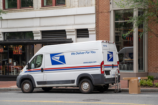 Washington, DC - August 5, 2019: A USPS (United States Postal Service) van is parked outside on a downtown Washington DC street, delivering packages and mail