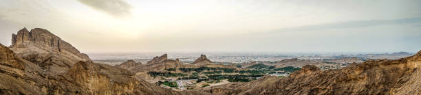 panorama view from the top of jebal hafeet, uae panorama view to al ain and oman from the top of the historic mountain jebel hafeet in the evening jebel hafeet stock pictures, royalty-free photos & images