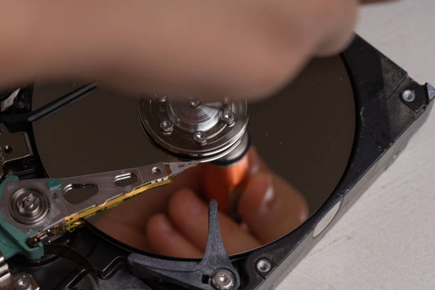 istock A teenager disassembles the hard drive of a computer to study its device. 1169993262