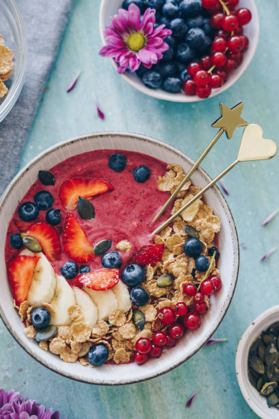 istock Smoothie bowl topped with fresh berries and granola 1169993327