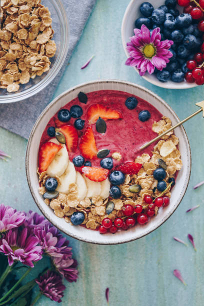 Smoothie bowl topped with fresh berries and granola
