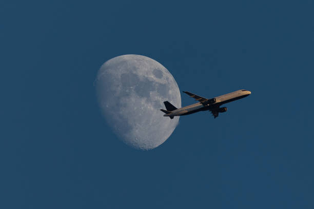 istock Aircraft against the moon, seen just before sunset (all plane identifiers have been removed) 1169996501
