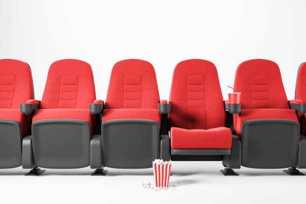 istock Row of red cinema chairs on white background 1169999050