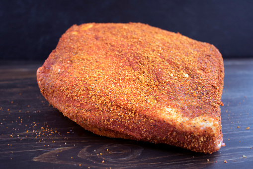 Raw beef brisket that has been rubbed with a spice mixture