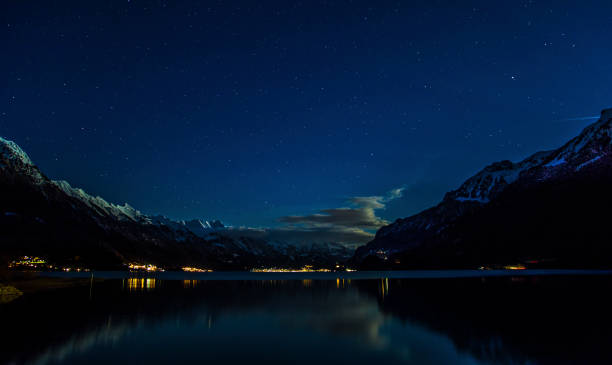 View of starry night on the snow mountain and lakes at Interlaken, Switzerland. The starry starry night of Interlaken lakes, a little cloud around the mountain. stars in your eyes stock pictures, royalty-free photos & images
