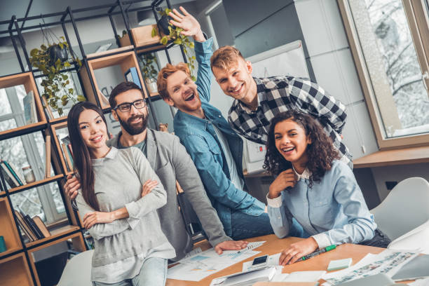 istock Startupers working together at office standing hugging looking camera cheerful 1170007595