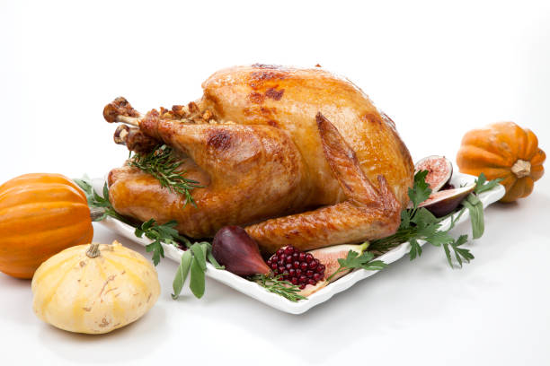 istock Traditional Roasted Turkey on White With Pumpkin 1170007692