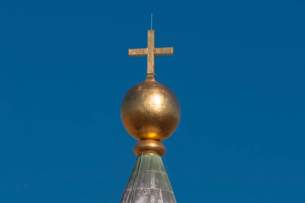 istock Golden cross with blue sky on the background 1170007755