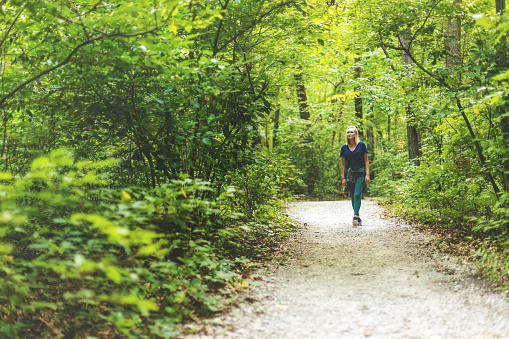 Millennial Adult Female Hiking in Nature Reserve in the Mid West USA (Shot with Canon 5DS 50.6mp photos professionally retouched - Lightroom / Photoshop - original size 5792 x 8688 downsampled as needed for clarity and select focus used for dramatic effect)