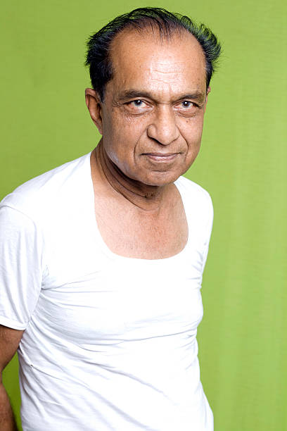 istock Cheerful Indian Senior Man on Green Background 117001569