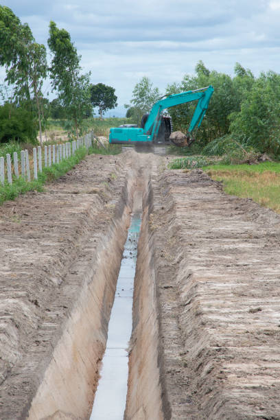 istock Backhoe digging waterway at agriculture area. 1170021441