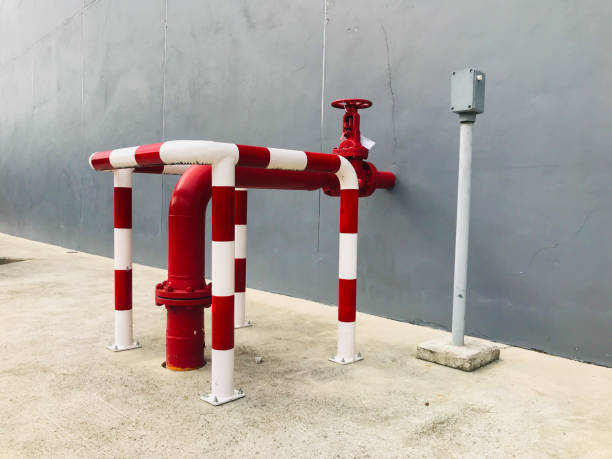 istock Fire hydrant fixed and guarded by Steel pipes painted both White and red for protection. guard pipe for protect fire hydrant system. pipe and valve fire hydrant pump. 1170022127