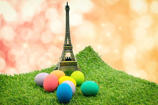 abstract colorful of easter eggs with small Eiffel Tower and bokeh background