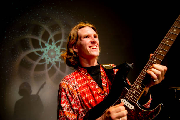 istock Young male performer plays his guitar with passion. Smiles. 1170025349