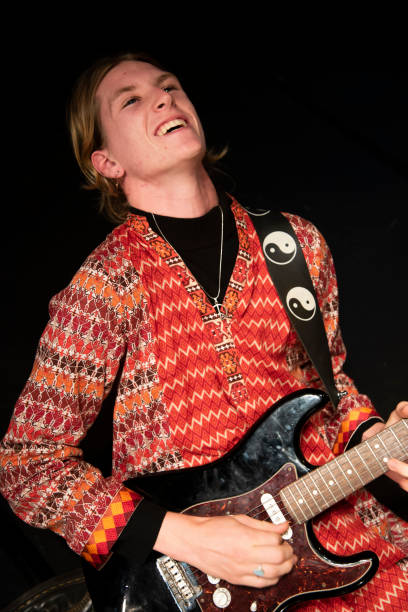 istock Young male performer plays his guitar with passion and joy. 1170025383