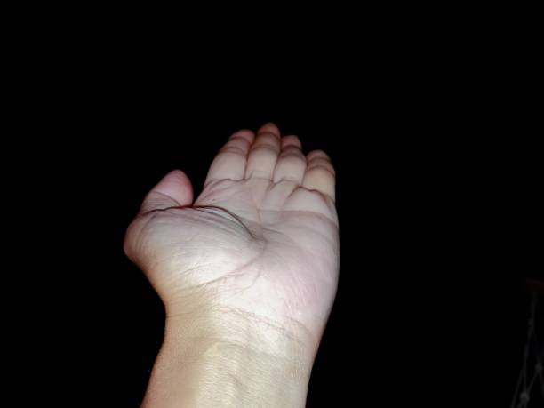 istock The man's hand on the black background 1170025990