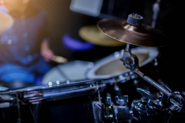 istock Selective focus to mini cymbals of drum set with blurry kid learning and play drum set with teacher in music room. 1170031527
