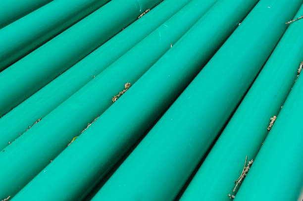 close-up of green pipes stacked at construction site for sanitary installation