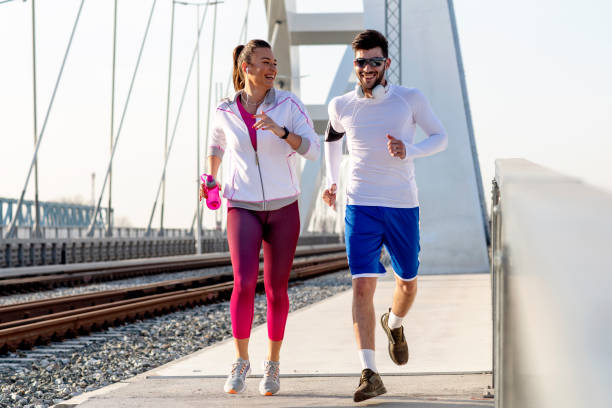 istock Couple jogging at the bridge 1170034885