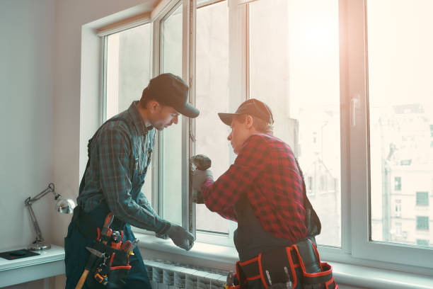 Provading best service. Men are installing a window Portrait of mature men wearing uniform standing indoors and installing new windows in the apartment. Horizontal shot window stock pictures, royalty-free photos & images