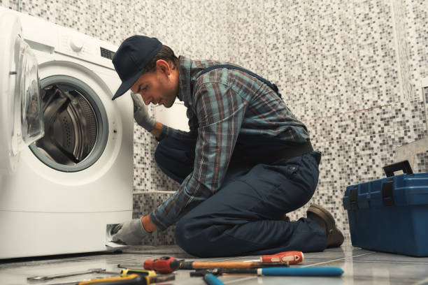 istock High quality workmanship. Plumber repairing washing machine 1170038010