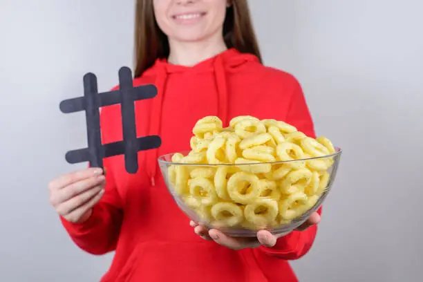 Photo of People person share free time concept. Cropped closeup photo of positive cheerful satisfied cool good pretty lovely girl holding bowl with round crisps isolated gray background