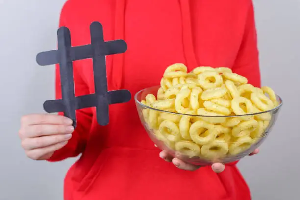 Photo of People person share free time concept. Cropped closeup photo of positive cheerful satisfied cool good pretty lovely girl holding bowl with round crisps isolated gray background