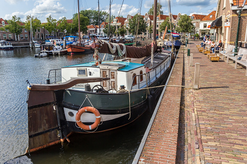 Quayside at the harbor of Oudeschild on Texel island, with a shrimp trawler docked.