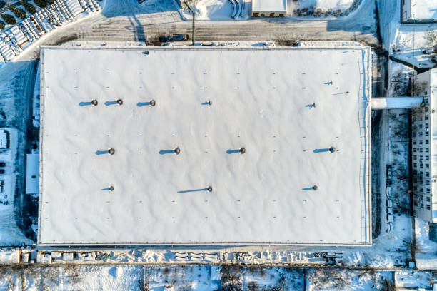 Cargo industrial warehouse, sunny winter day. Aerial view