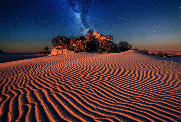 Night sky over sand dunes desert landscape Sand dunes rippled by the wind under the starry night sky outback stock pictures, royalty-free photos & images