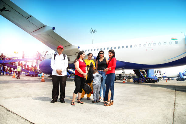 Indian family standing at airport in front of airliner Family standing in front of passenger plane. An airliner is a type of aircraft for transporting passengers and air cargo. Such aircraft are most often operated by airlines. Although the definition of an airliner can vary from country to country, an airliner is typically defined as an aeroplane intended for carrying multiple passengers or cargo in commercial service. india airport stock pictures, royalty-free photos & images