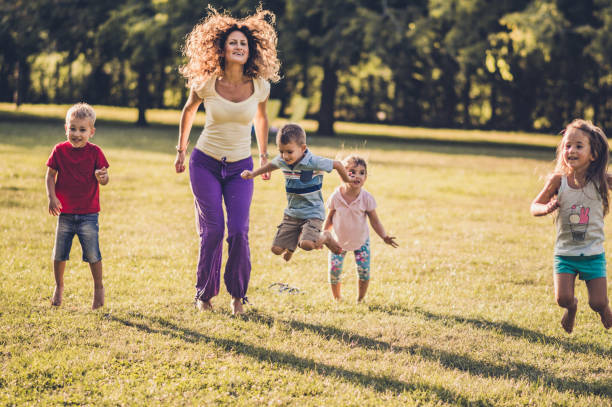 istock Happy kids jumping in nature 1170044208