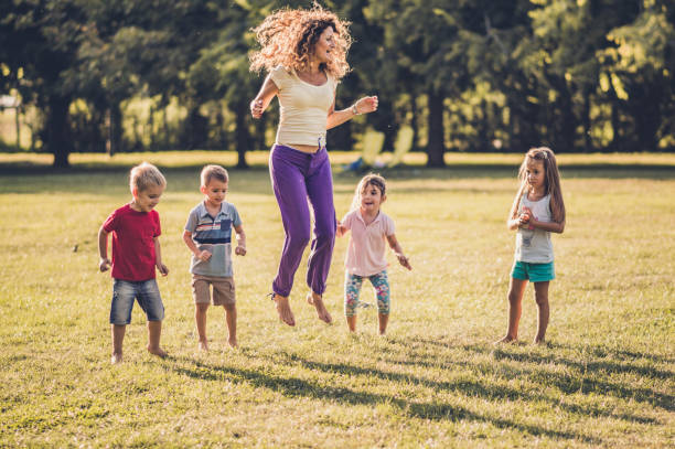 istock Happy kids jumping in nature 1170044260