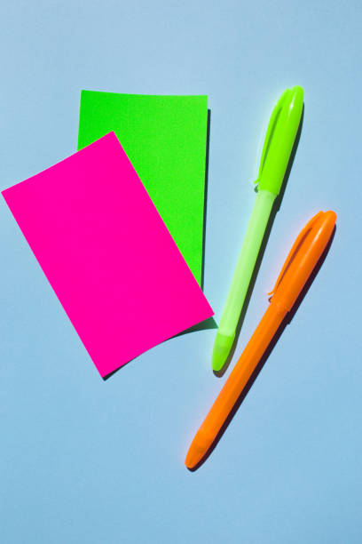 istock Neon colorful sticky note paper and pen on blue background. 1170045834