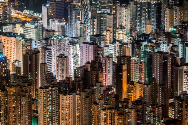 hong kong kowloon skyline - city night china lighting equipment stock-fotos und bilder