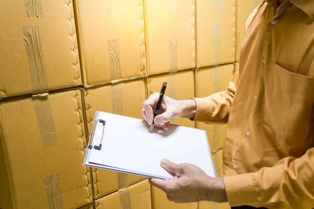 istock Manager checking stock products in warehouse. 1170047692