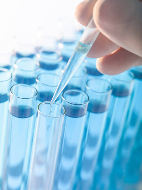 istock Droplet Falling from Pipette into Test Tube 1170050889