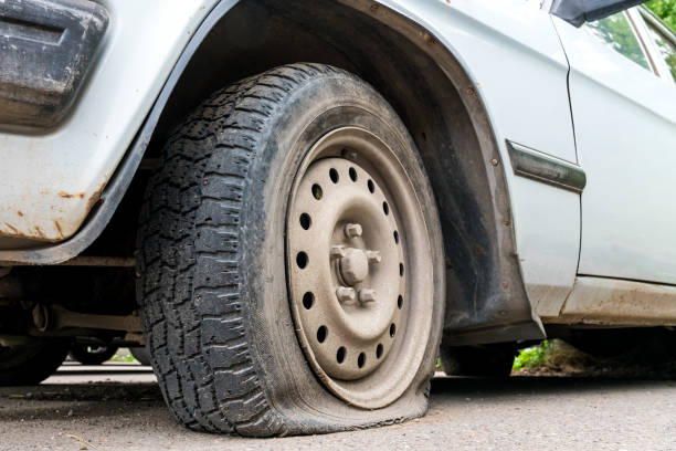 istock car wheel flat tire on the road 1170051239