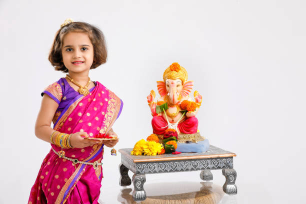 Little indian Girl with lord ganesha Little indian Girl with lord ganesha beautiful traditional indian girl stock pictures, royalty-free photos & images